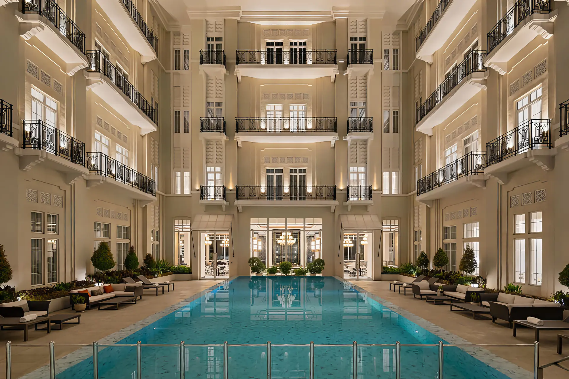 Courtyard and pool view of The Grand Mansion in Menteng, South Jakarta, featuring elegant white windows with french profiles.